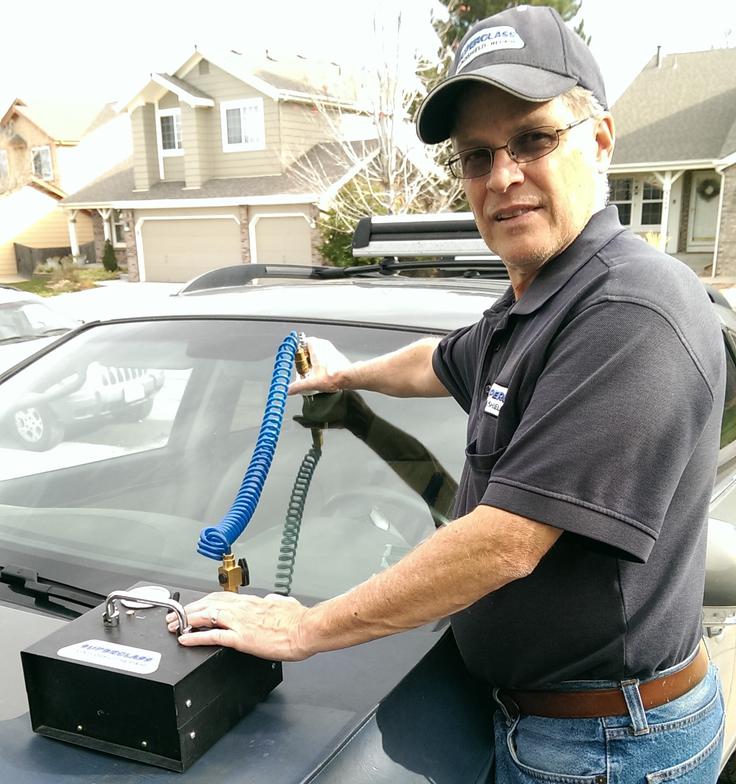One of our employees doing chip repair services in Denver, CO